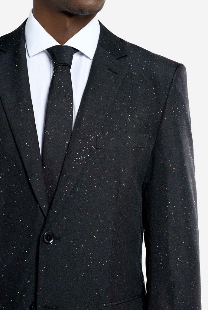 Image of a man wearing an OppoSuits Glitzy Glitter men's suit with glitters and white men's shirt. Suit consist of pants, jacket and tie.