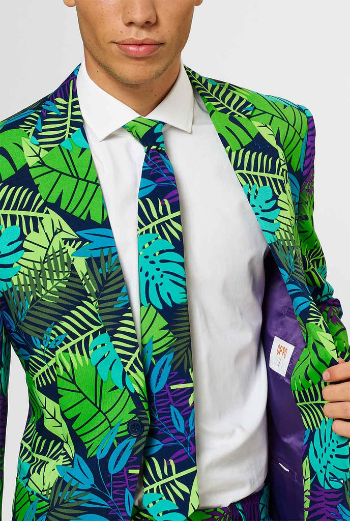 Jungle print men's suit with green and purple leaf print worn by man