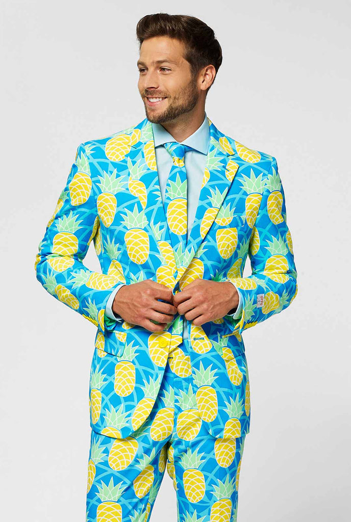 Pineapple print men's suit with bright colors by man close up