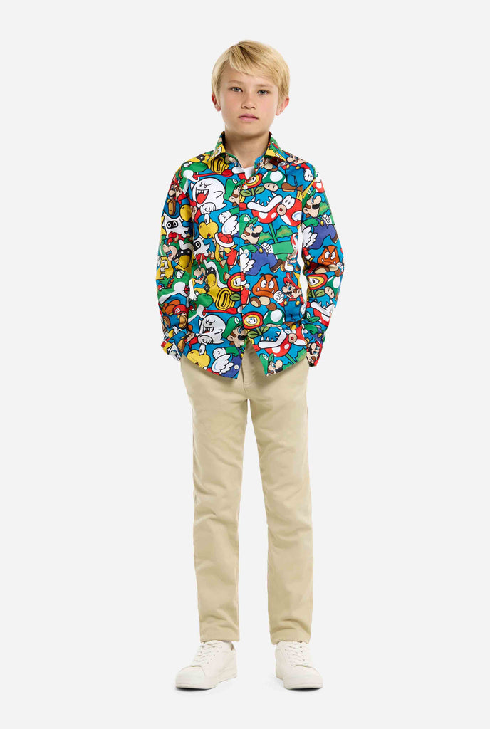 Image of teen wearing a Super Mario all over print shirt. Main color is blue, but there is also yellow, red and white.