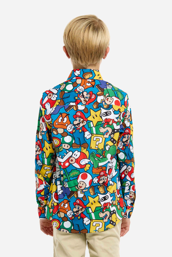 Image of teen wearing a Super Mario all over print shirt. Main color is blue, but there is also yellow, red and white.