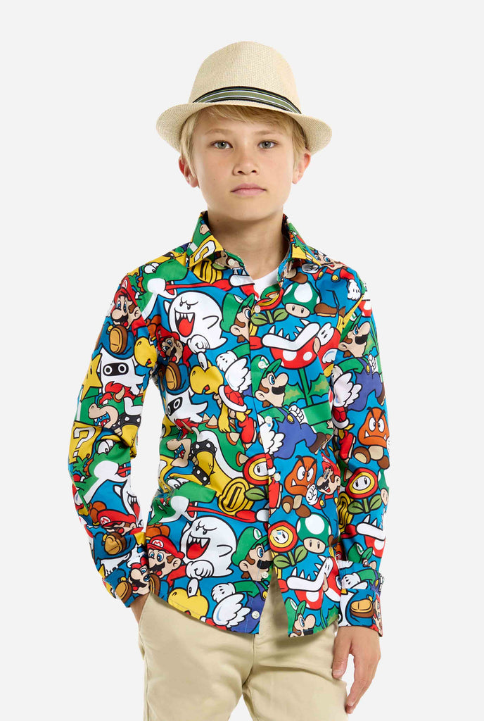 Image of teen wearing a Super Mario all over print shirt. Main color is blue, but there is also yellow, red and white.