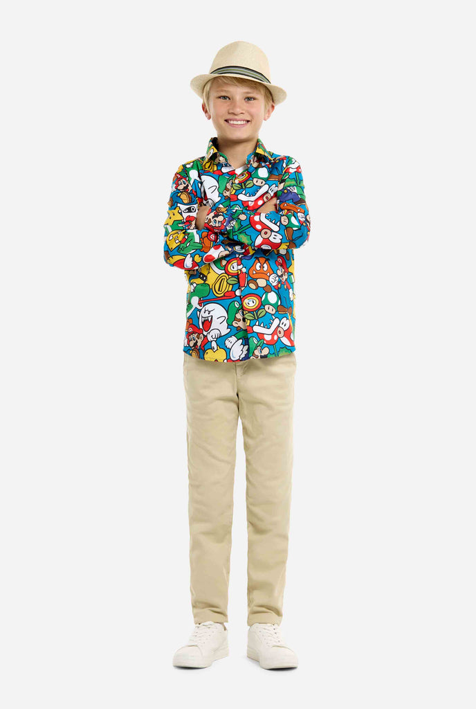 Image of teen wearing a Super Mario all over print shirt. Main color is blue, but there is also yellow, red and white.