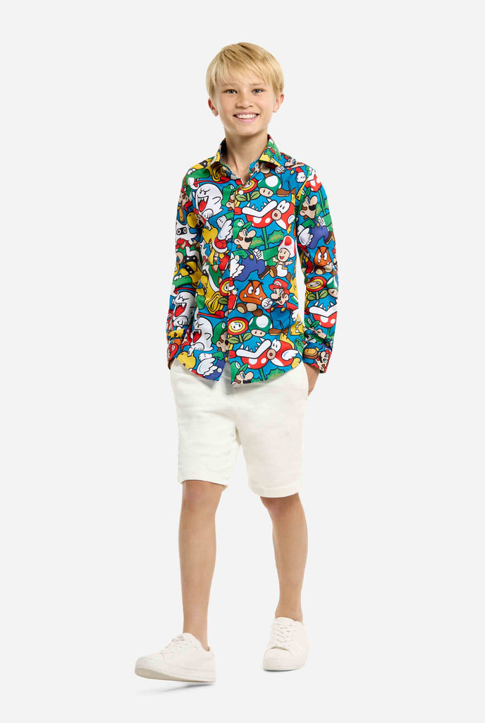 Image of teen wearing a Super Mario all over print shirt. Main color is blue, but there is also yellow, red and white.