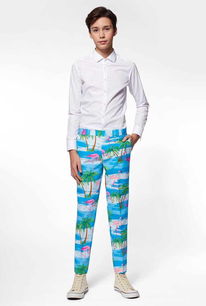 Teen wearing light blue suit with flamingo palm tree print