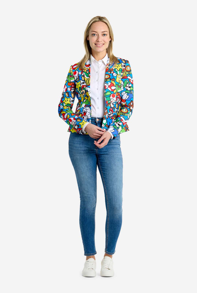 Woman wearing all-over print Super Mario blazer with iconic Super Mario characters. The base is light blue, but there is also yellow, red and white.