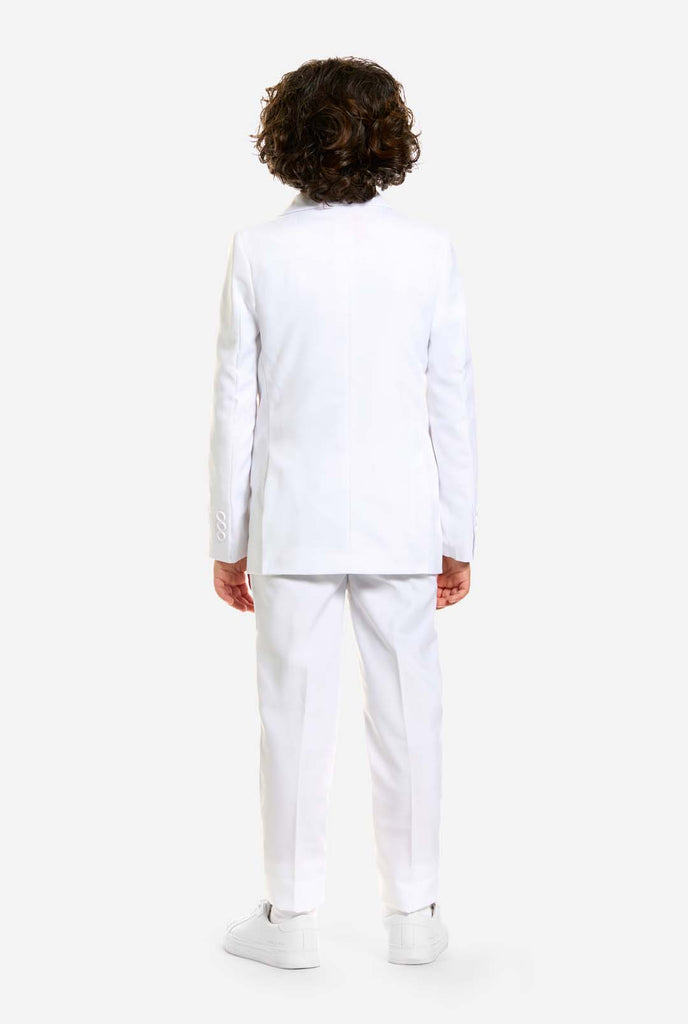 In this image, a kid is wearing a white suit for boys and white shirt. The consists of jacket, pants and clip-on tie.