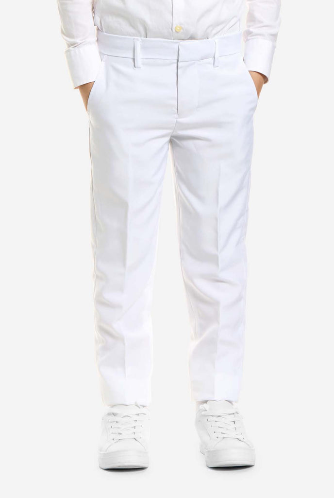 In this image, a kid is wearing a white suit for boys and white shirt. The consists of jacket, pants and clip-on tie.