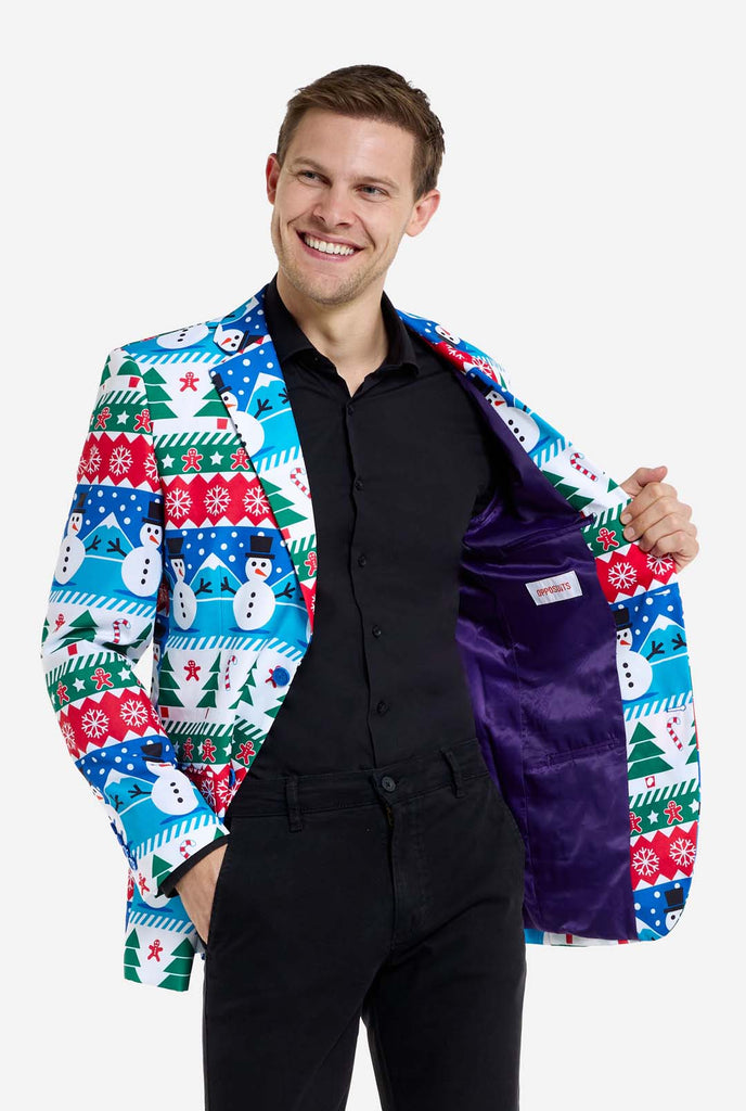 Man wearing Christmas blazer for men with Christmas winter figures. Man also wearing a black pants and black men's shirt. Showing purple inside of jacket.