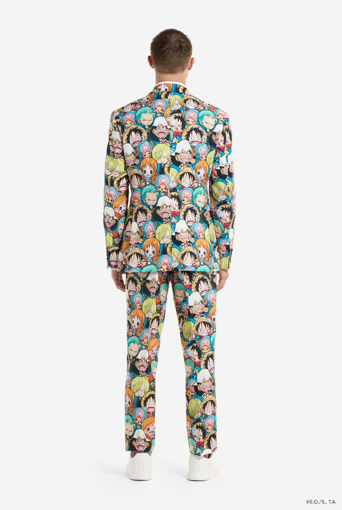 Man is wearing a men's suit with all over One piece print with One Piece characters. View from the back.