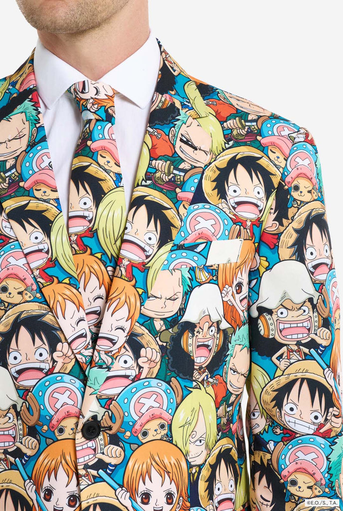 Man is wearing a men's suit with all over One piece print with One Piece characters. Chest close up.
