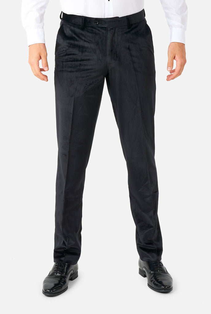 Man wearing black velvet tuxedo, pants view