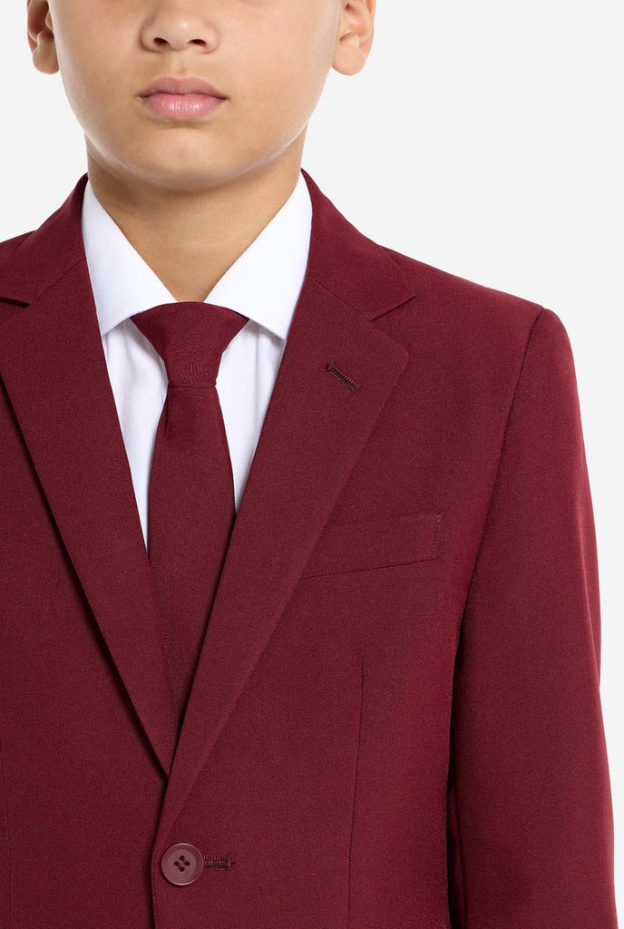 Teen wearing formal burgundy red suit, close up