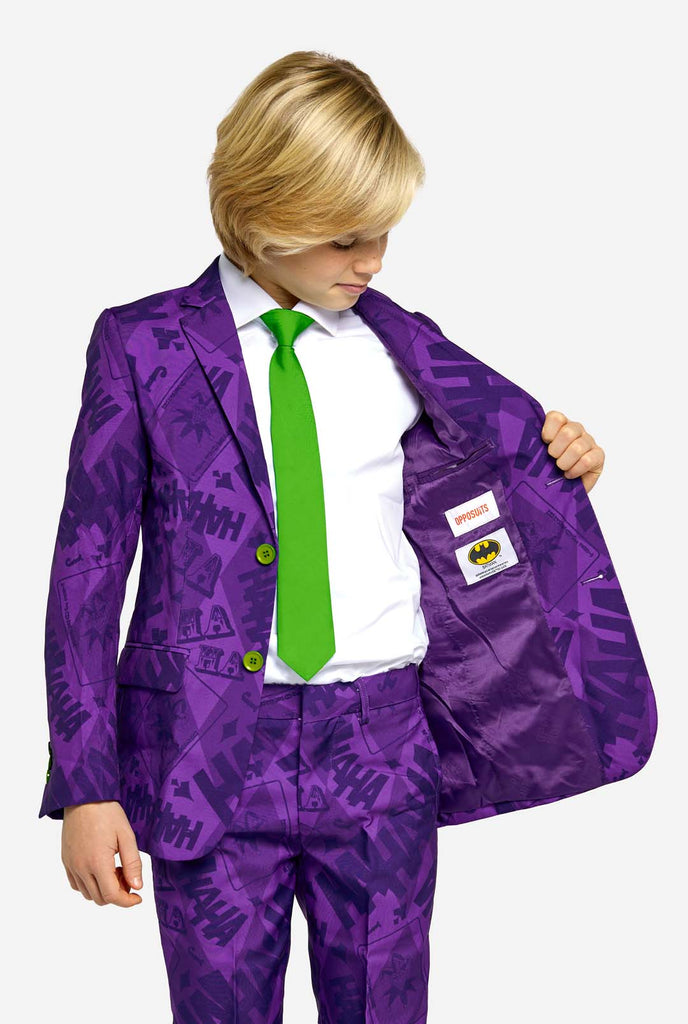 Teen wearing purple teen boys suit with a The Joker theme and green buttons. Further he is wearing a green tie and a white shirt. Showing inside of jacket.