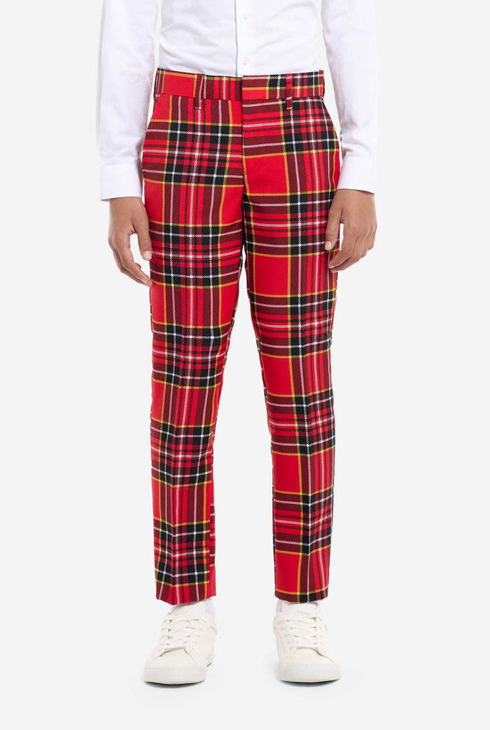 Teen wearing red tartan Christmas suit, pants view