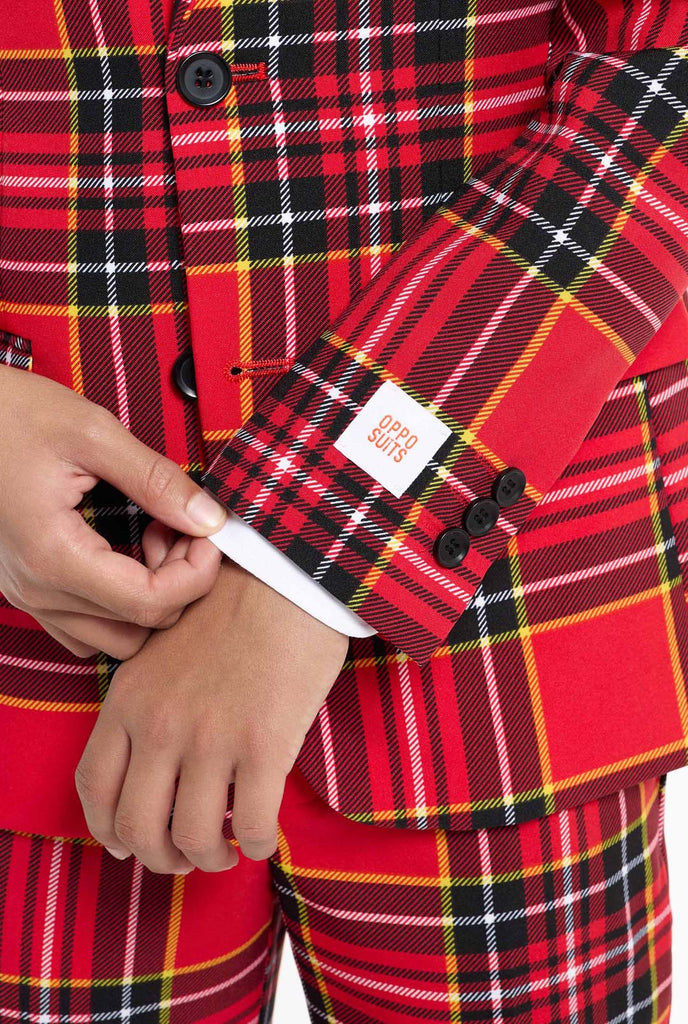 Teen wearing red tartan Christmas suit, close up