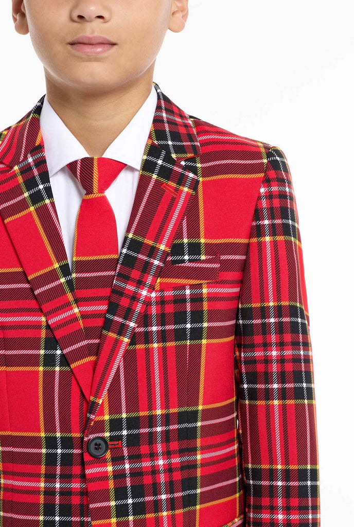 Teen wearing red tartan Christmas suit, chest close up