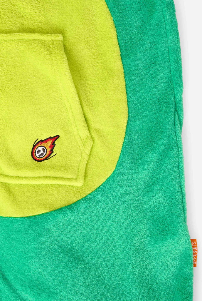 A kid is wearing a green dinosaur kids onesie featuring playful hood details and cozy, soft material, perfect for lounging or costume events. Kangeroo pocket close up.