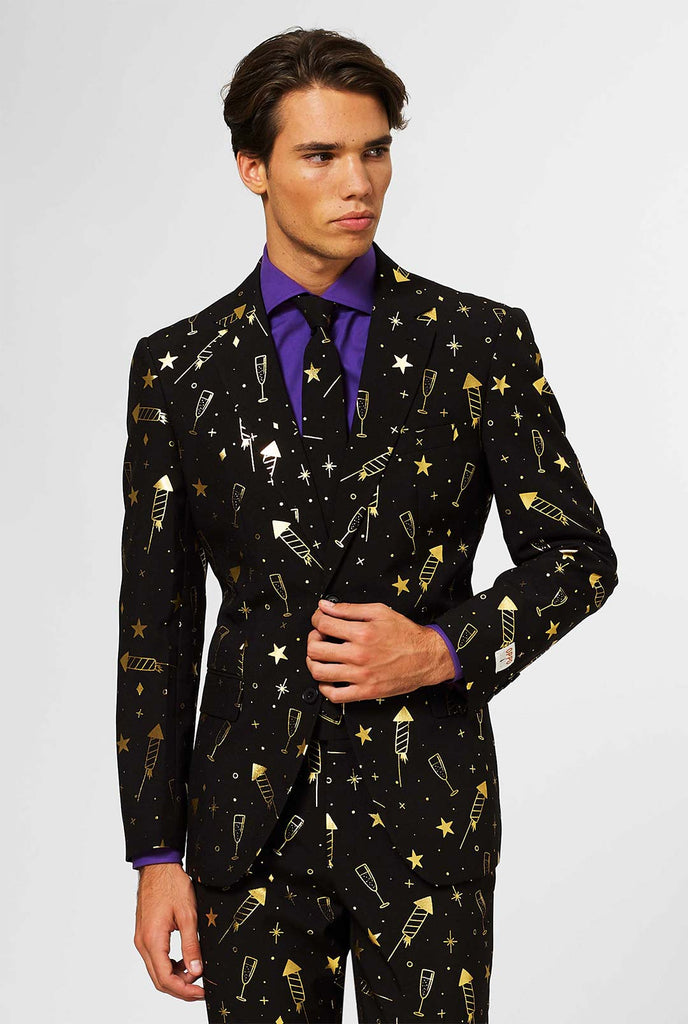 Video of black men's suit with golden fireworks print worn by man