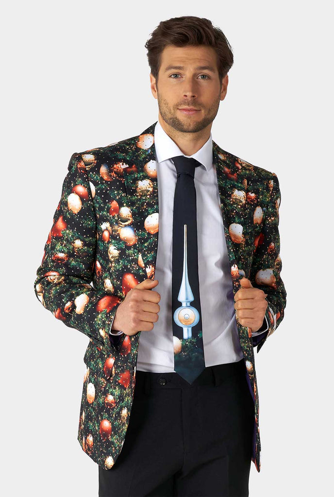 Video of man wearing Christmas suit with Christmas tree print