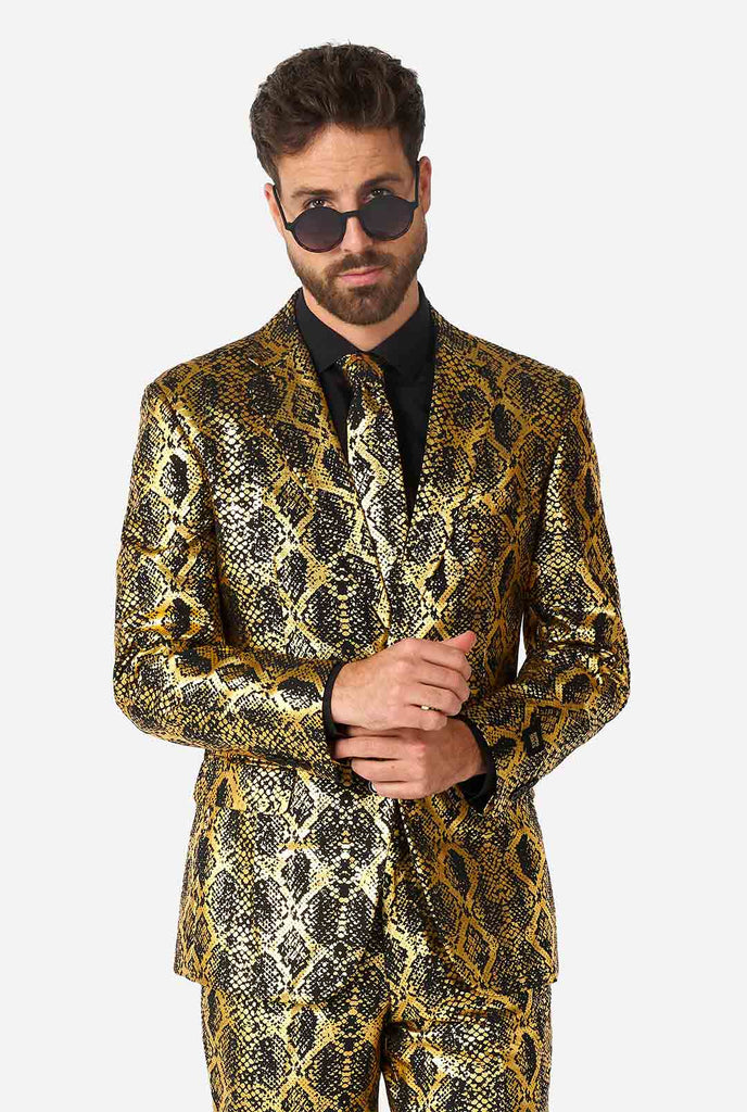 Video of man wearing suit with, gold and black, snakeskin print