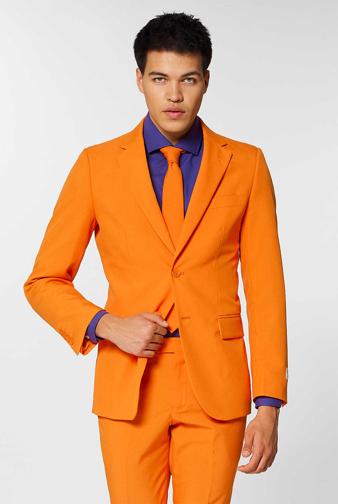 Video of man wearing orange men's suit with dress shirt