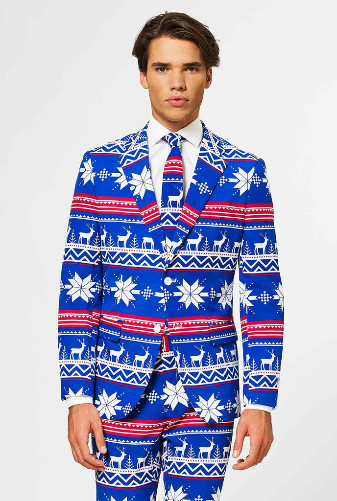 Video of man wearing blue Christmas suit with Nordic themed print